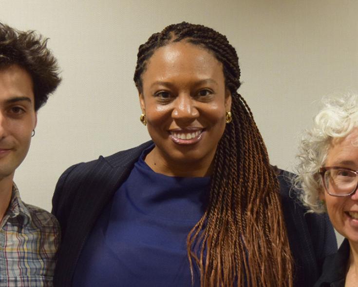 Three poeple smiling at the camera.