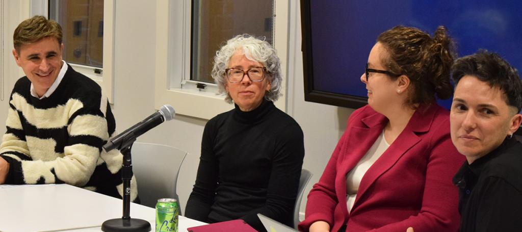 People sitting at a table with a microphone.