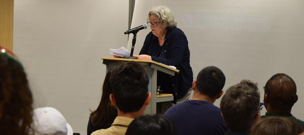People seated listening to a speaker.